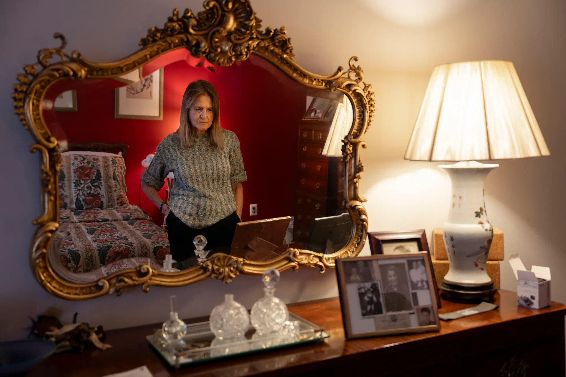 Marian Kornicki looks at old family photos in what used to be her parents' bedroom, at her home in Roslyn Heights, N.Y., on Dec. 6, 2024. Samira Bouaou/The Epoch Times